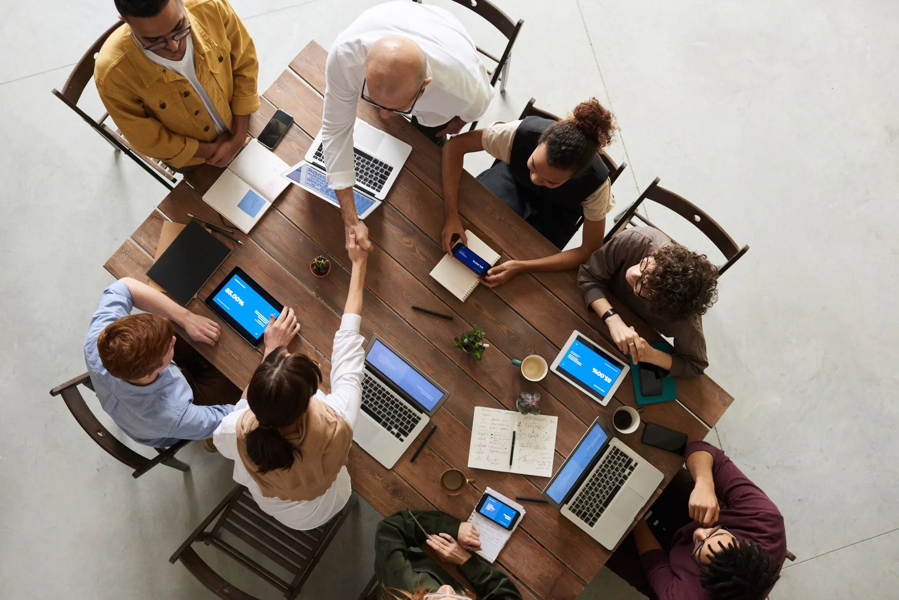 A team working together around a shared table, seen from above