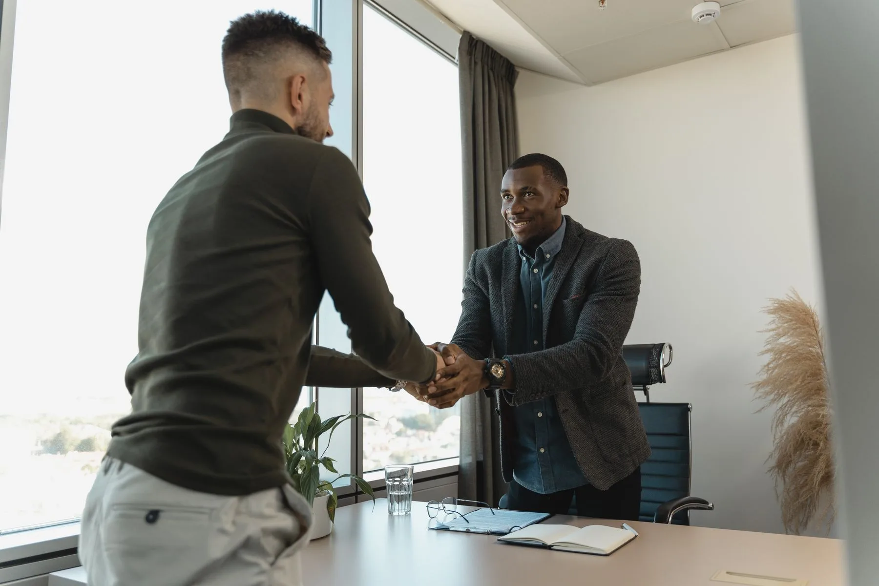 Two colleagues shaking hands at the end of an interview