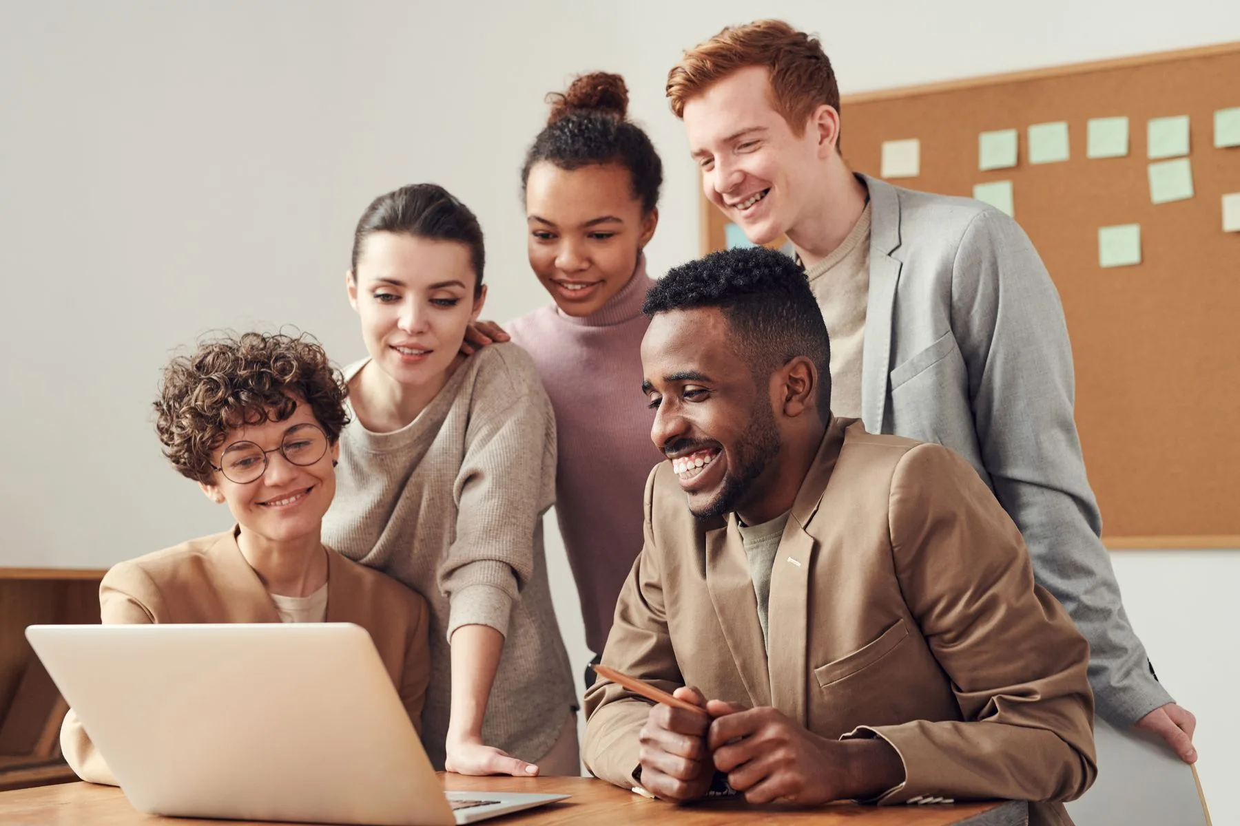Colleagues learning together around a laptop